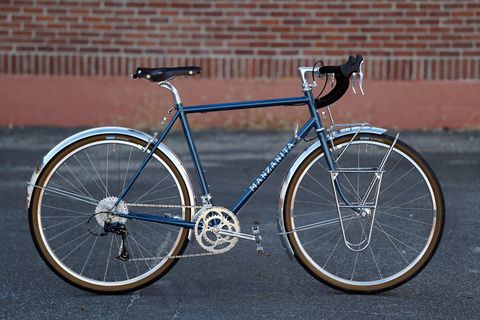 Randonneuring bike with silver fenders, custom racks, and dynamo lighting