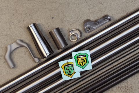 Reynolds steel tubes pictured with all the other raw materials that make up a bike frame.